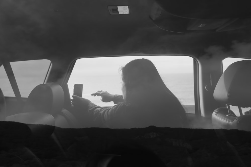 woman in black shirt sitting on car seat