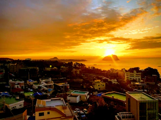 A vibrant sunset over Stone Town's historic rooftops, casting golden hues on the ancient architecture.