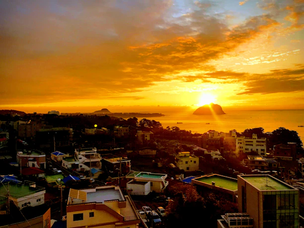 Warm sunset casting golden light over the historic buildings of Gorée Island.