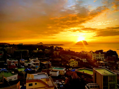 A vibrant sunset over Stone Town's historic rooftops, casting golden hues on the ancient architecture.