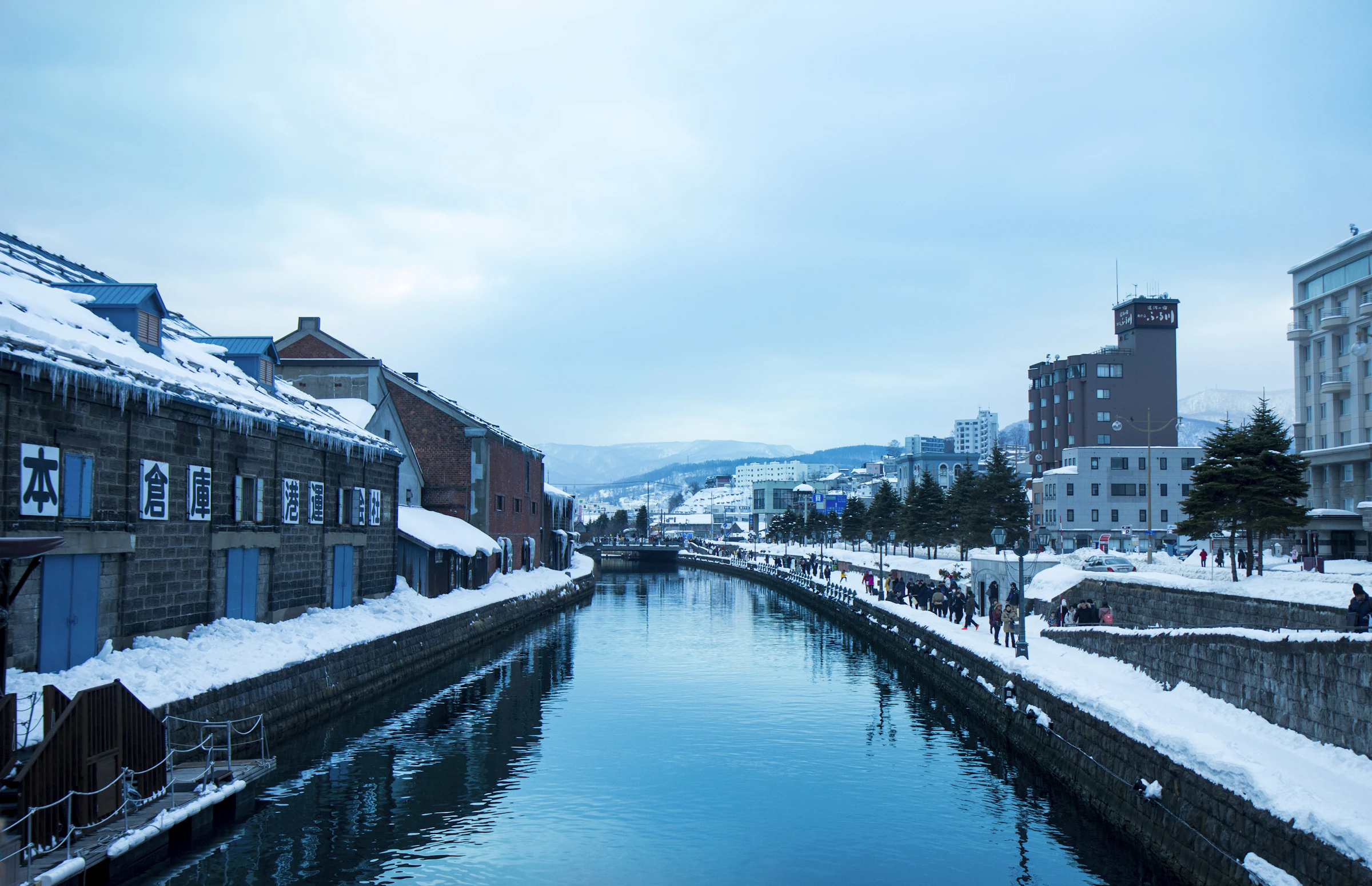 The historic Otaru Canal lined with snow-covered warehouses and a walking path