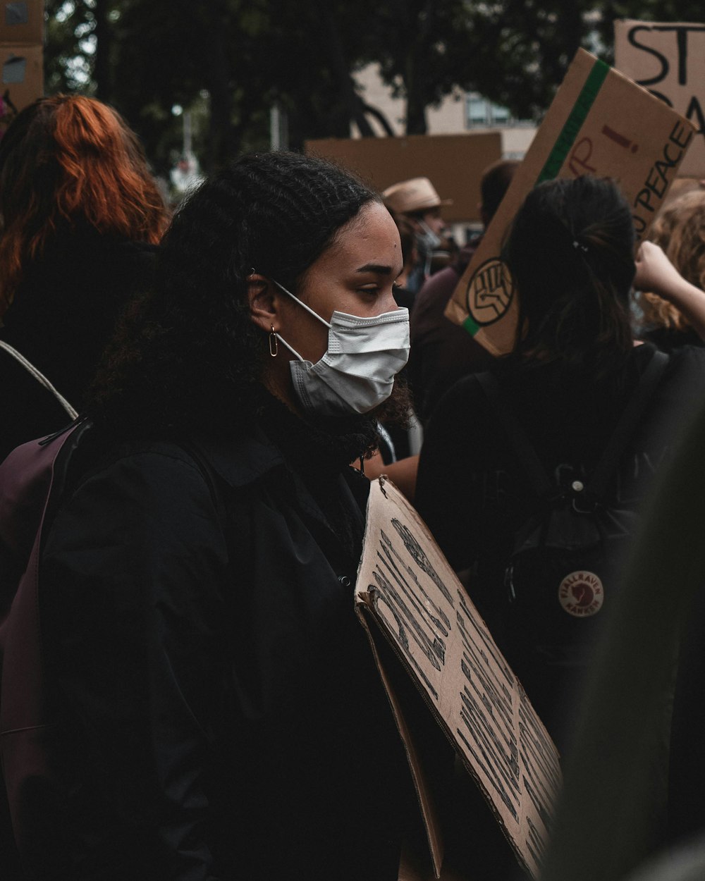 woman in black coat wearing white goggles