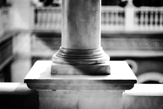 Elegant marble column with subtle golden accents in a modern office setting