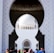 An architectural design featuring an ornate archway with a view of a domed building in the background. The intricate patterns and geometric shapes highlight a traditional style. People are gathered at the base, adding a contrast to the grand architectural elements.