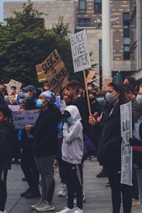 A diverse group of Oakland community members standing united in front of a neighborhood street.