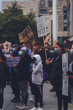 A group of diverse people gathered in a community meeting, discussing important social issues.