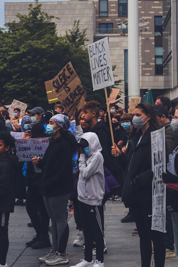 A diverse group of Oakland community members standing united in front of a neighborhood street.