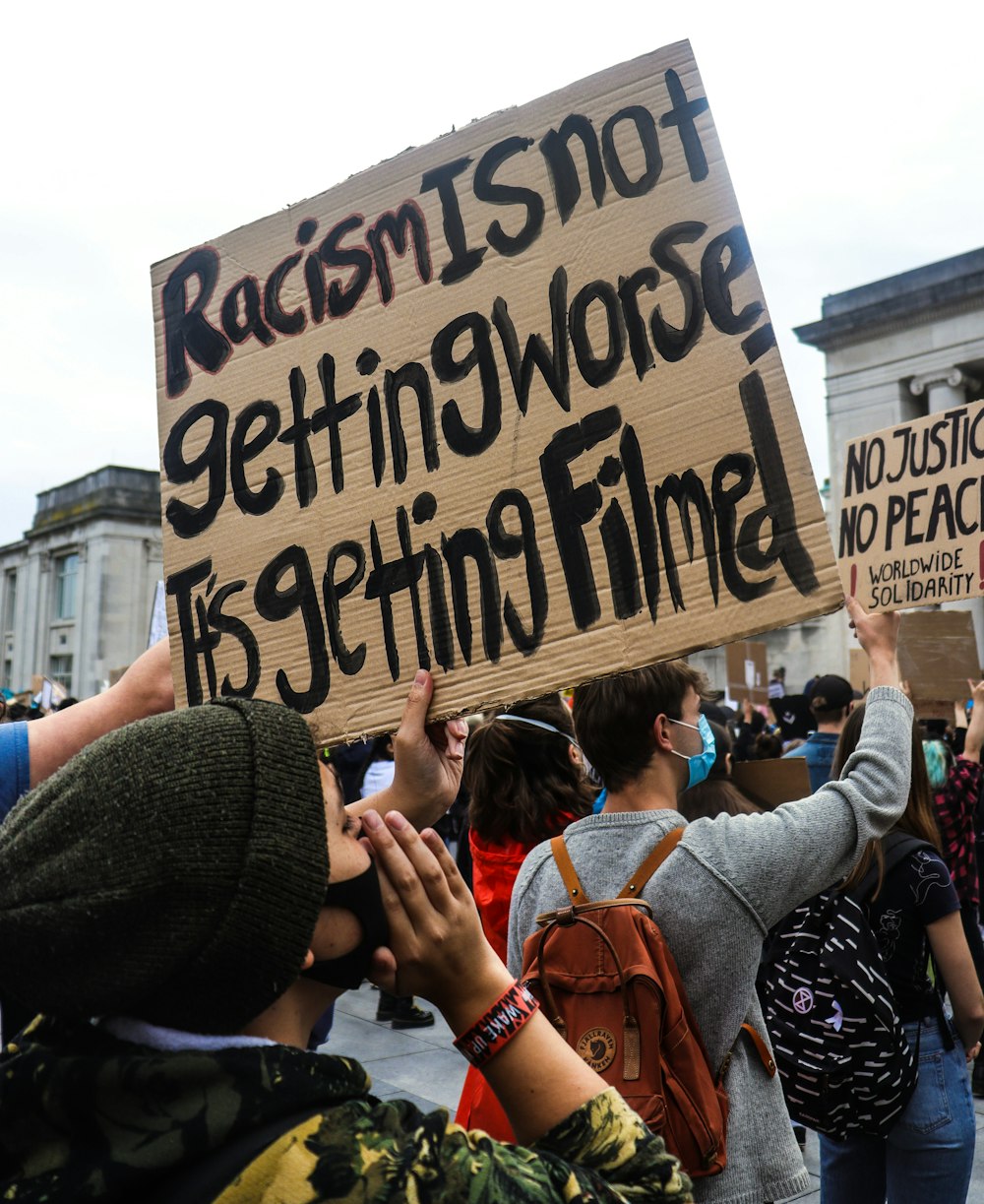 a group of people holding up a sign