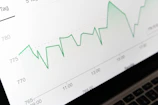 stock market chart displayed on laptop screen