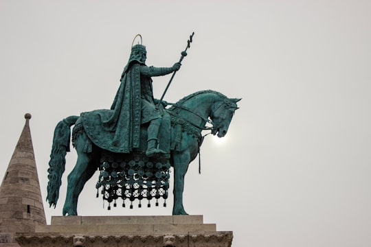 black statue of man riding horse in Fisherman's Bastion Hungary