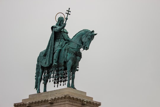 green statue of man riding horse in Fisherman's Bastion Hungary