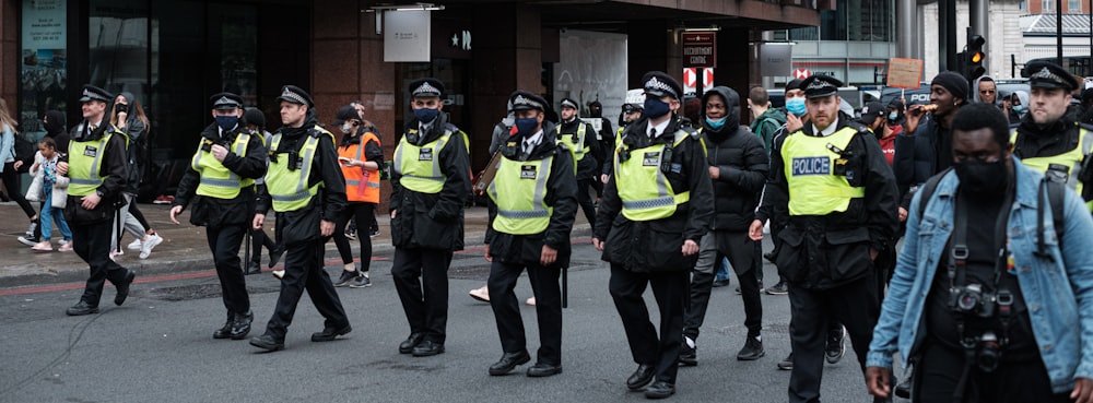 group of men in green and black backpacks