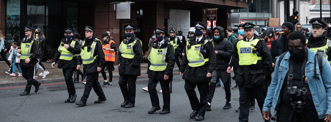 group of men in green and black backpacks, London Black Lives Matter Peaceful Protest from Vauxhall to Westminster.