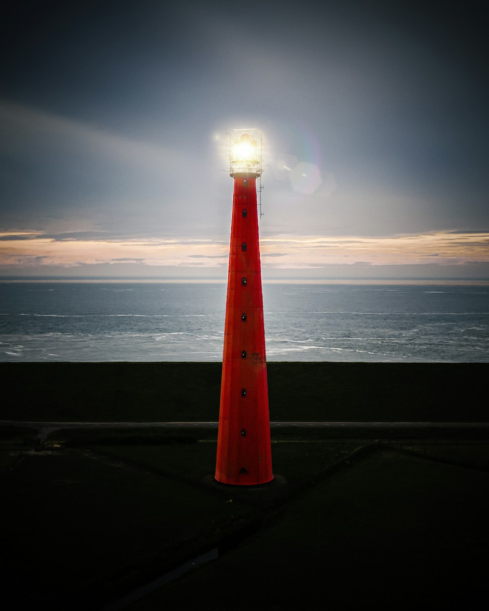 red and white lighthouse near sea during daytime