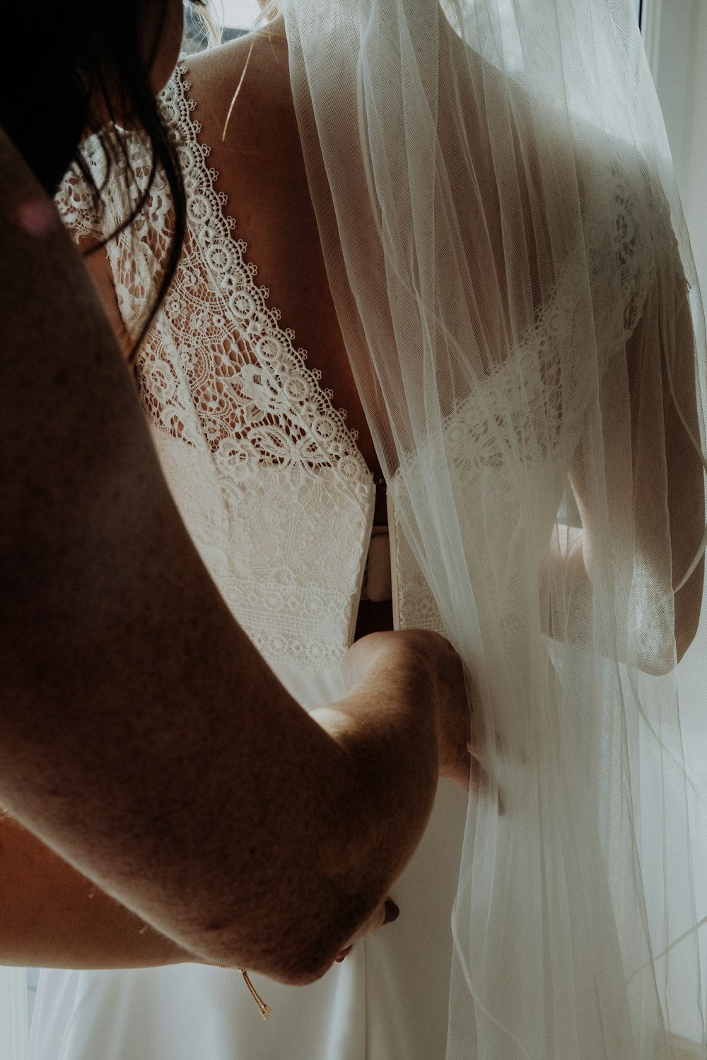 persons leg on white sheer curtain