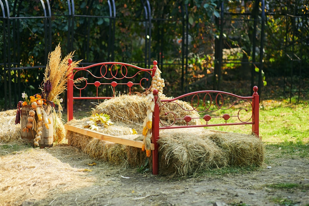 red wooden bench with brown hay
