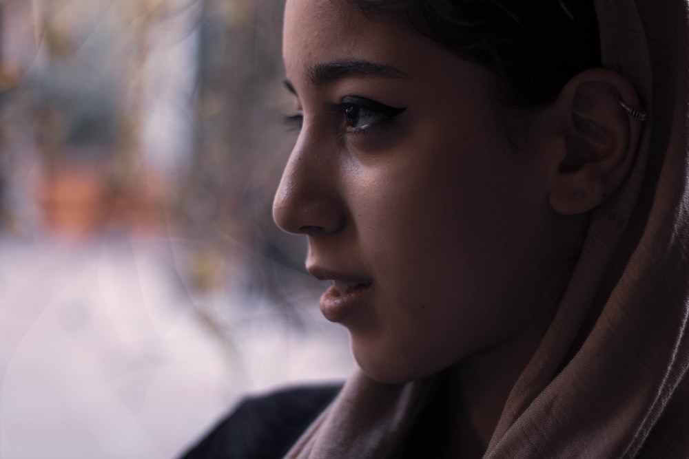 woman in brown hoodie looking down