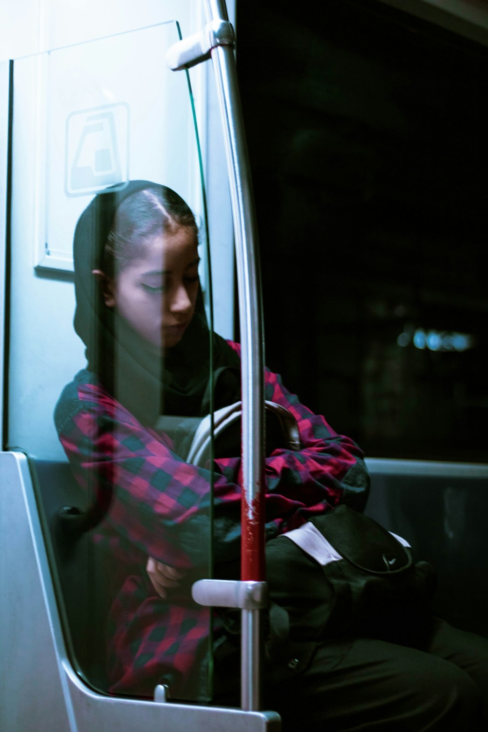 woman in red and black hijab sitting inside car