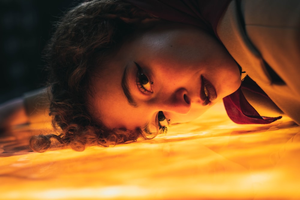 woman in black shirt lying on bed