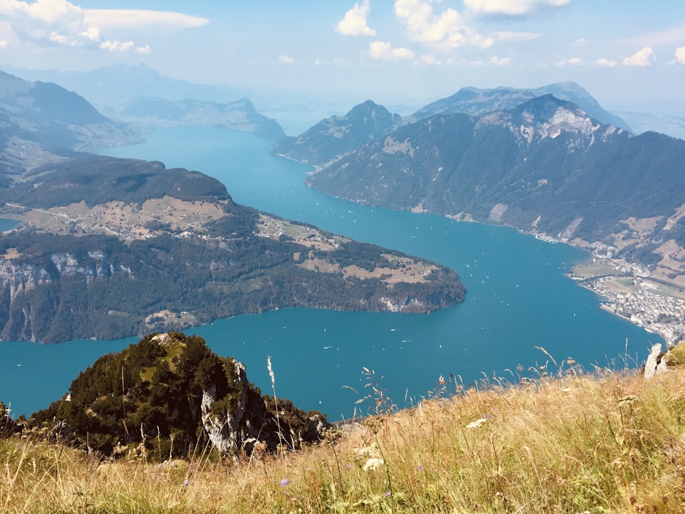 aerial view of lake in the middle of mountains during daytime