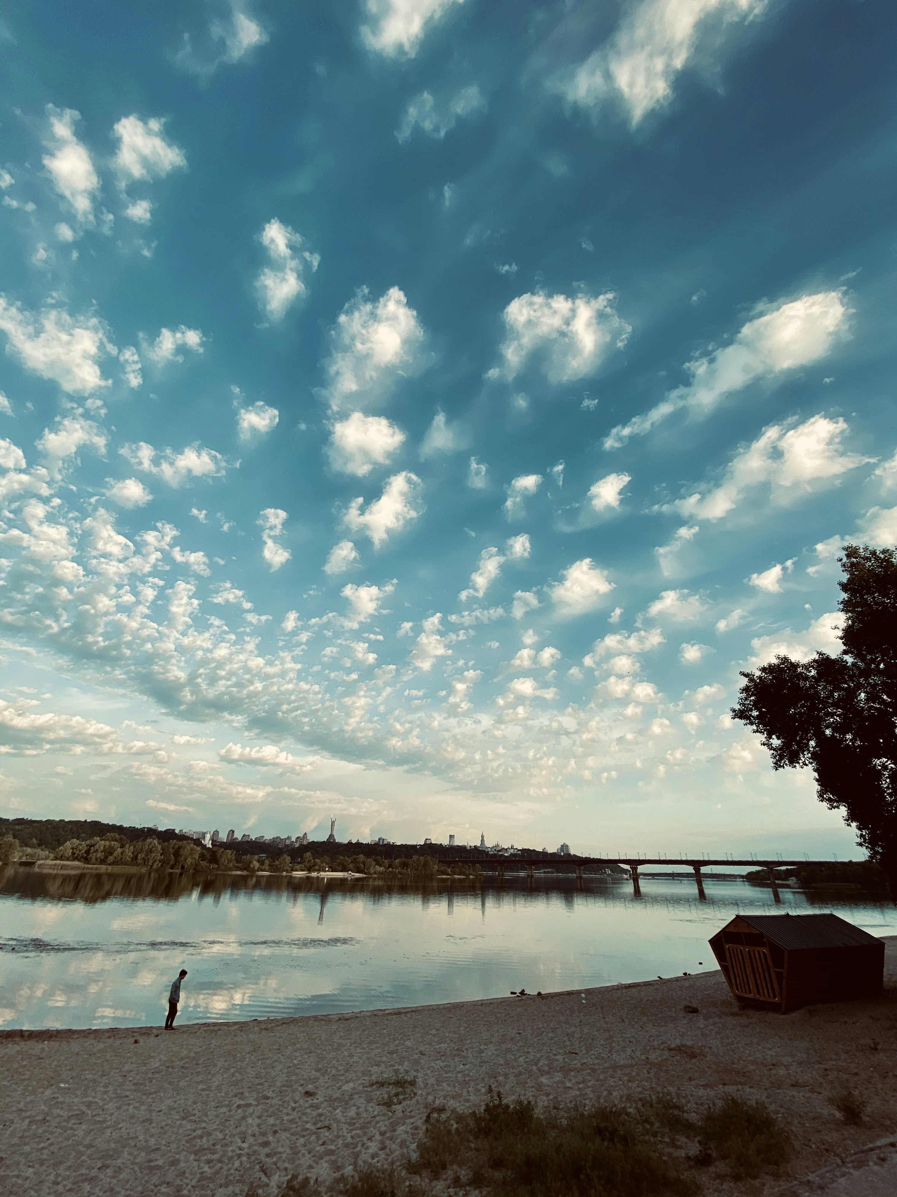 white and blue cloudy sky over lake