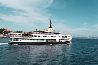 white and blue ship on sea under blue sky during daytime