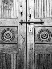 Close-up image of a finely crafted wooden door with natural wood grain texture.