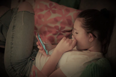 A person using a smartphone to place an order for home delivery in a cozy living room.