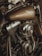 A close-up view of a motorcycle engine and fuel tank with a metallic shine. The brand logo is visible on the tank, and the chrome parts reflect light, suggesting a well-maintained machine. The detailed components of the engine are prominently displayed.