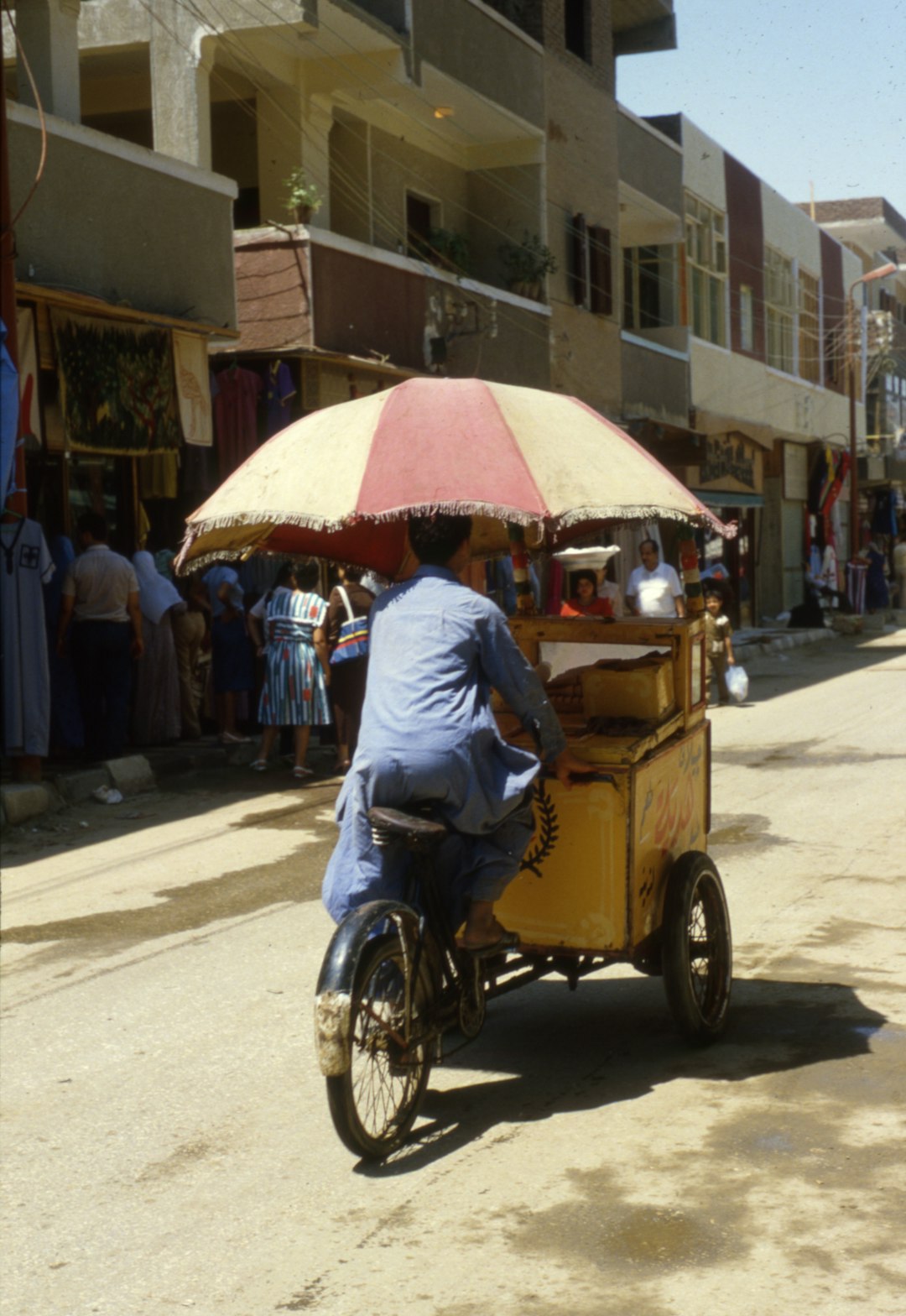 man in blue long sleeve shirt riding yellow auto rickshaw on road during daytime