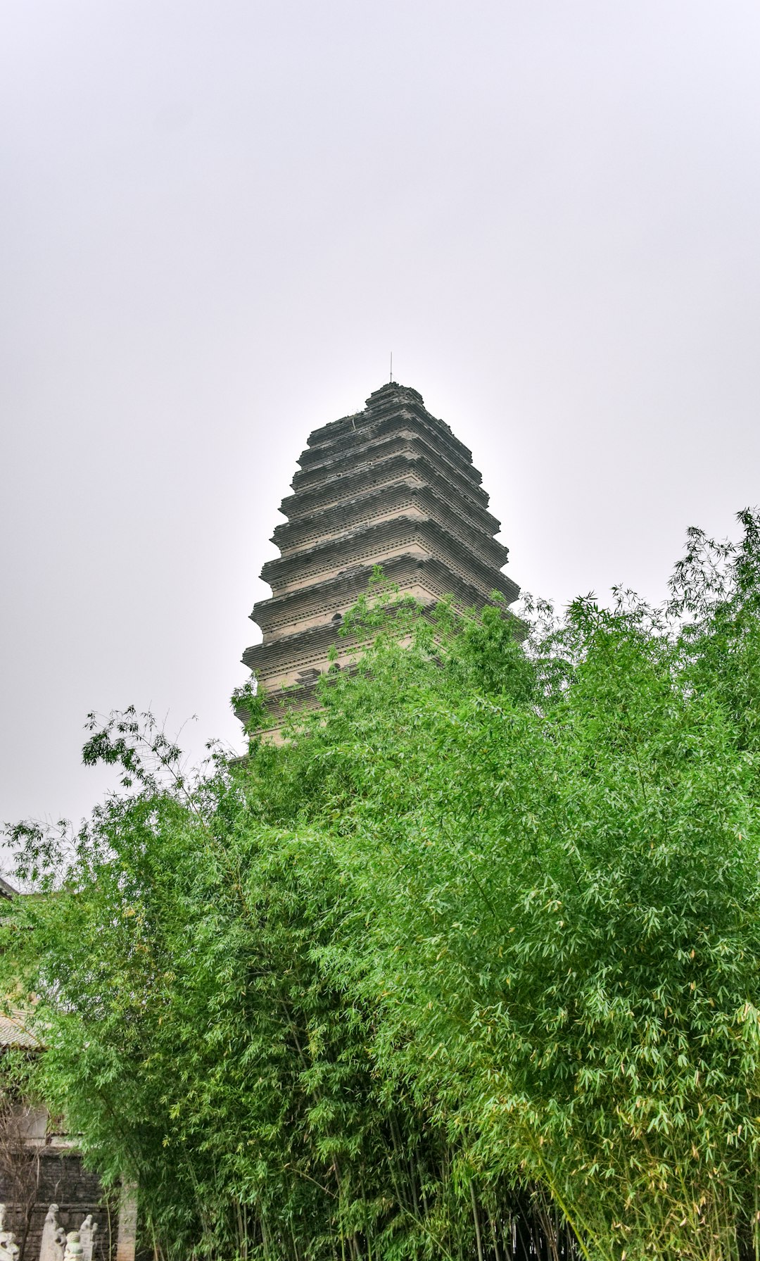 brown concrete temple near green trees during daytime