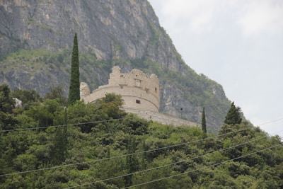 Historic stone fortress nestled among lush green hills in Georgia