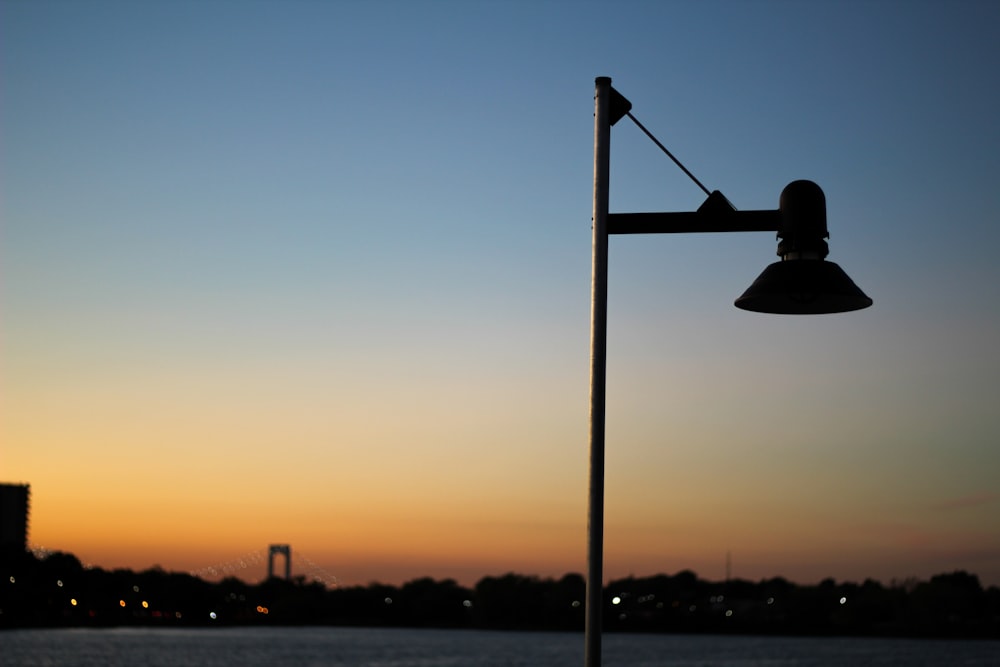 black street light during sunset