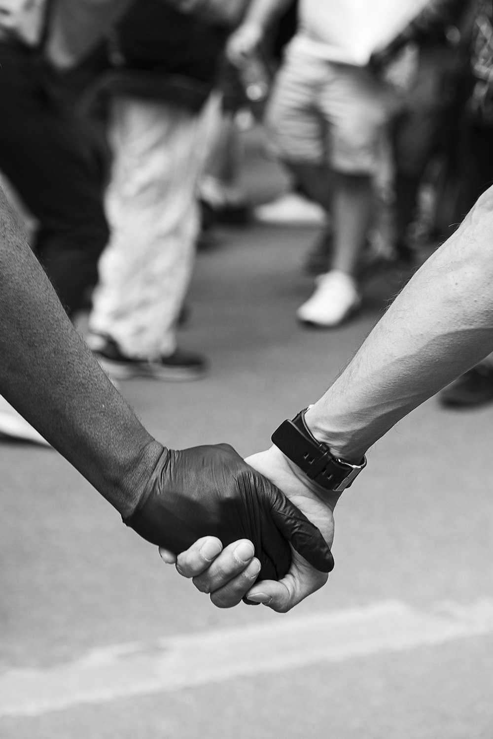 grayscale photo of man and woman holding hands