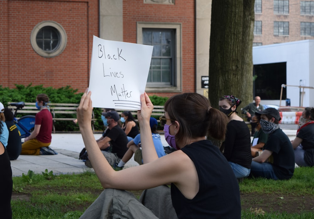 people sitting on green grass field during daytime