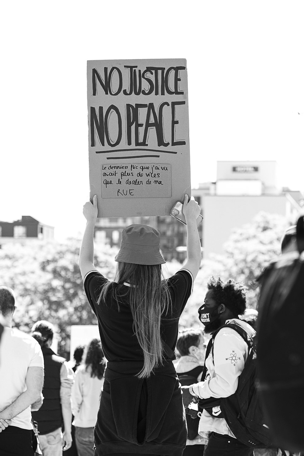 grayscale photo of people holding white and black banner