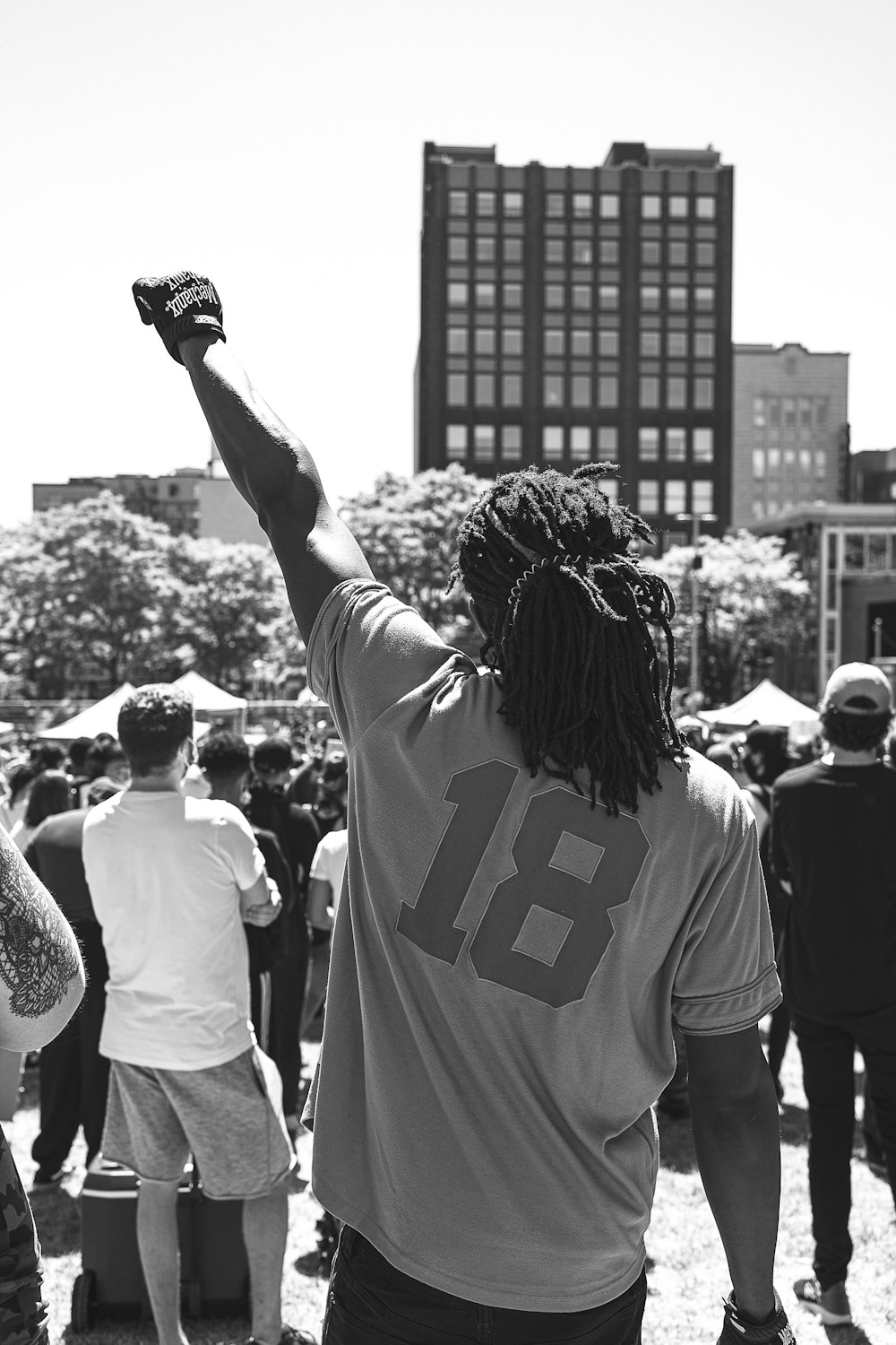 woman in white and black t-shirt raising her hands