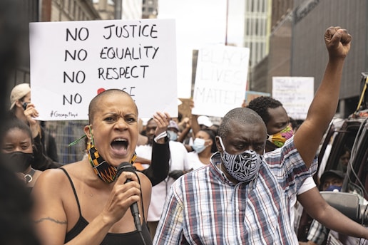 A group of minority rights advocates speaking passionately at a community meeting.