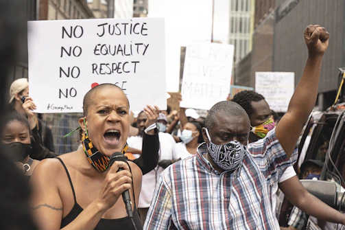 Community leaders speaking passionately at a local event advocating for social justice and dignity.