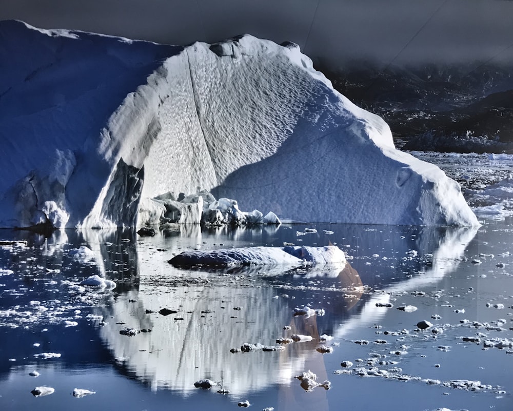 ice on water near mountain during daytime