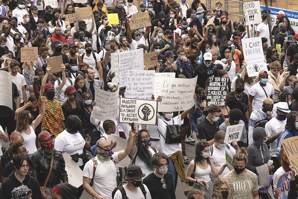 people sitting on chair holding white printer paper during daytime