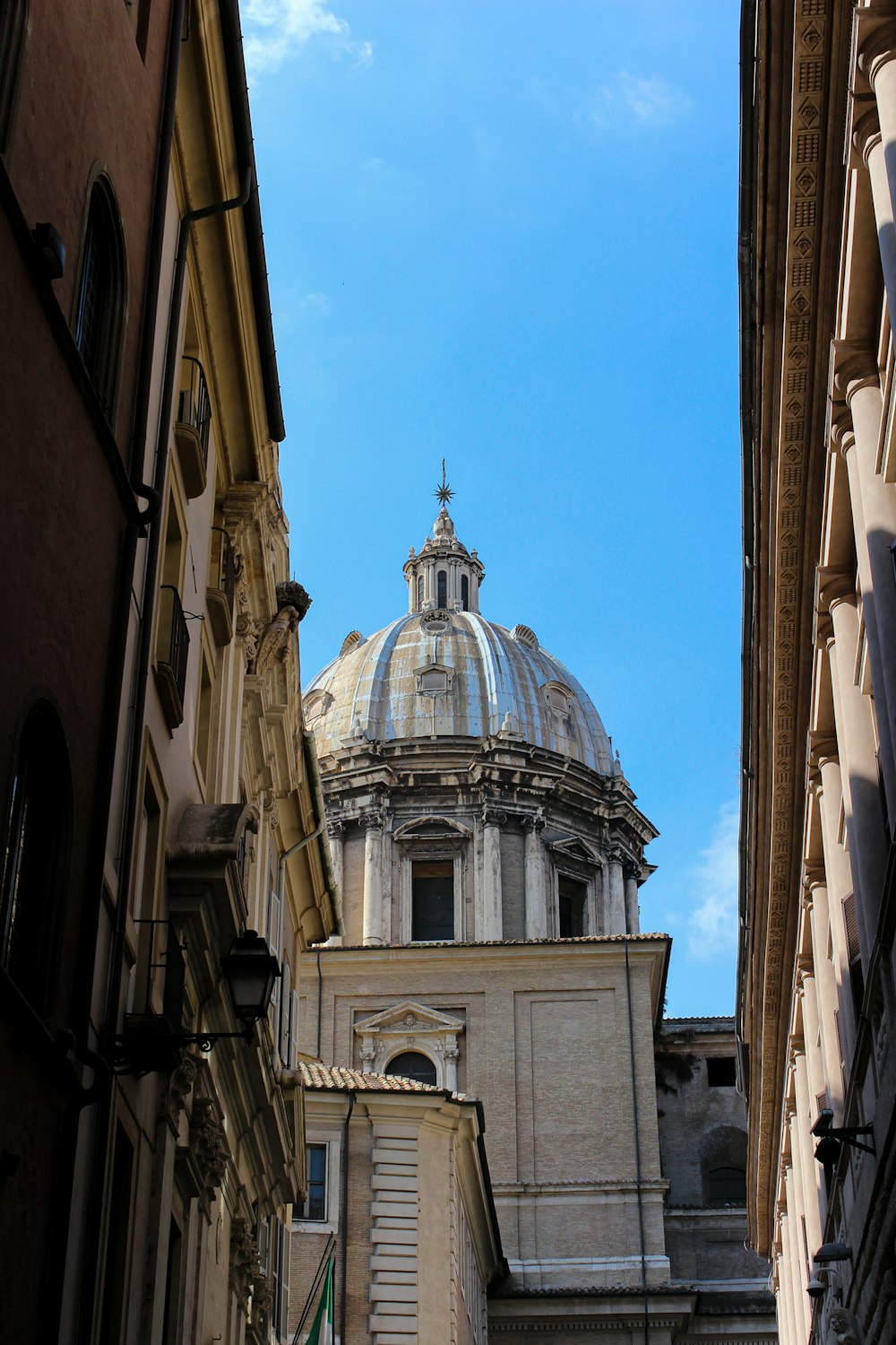 brown and white concrete building under blue sky during daytime