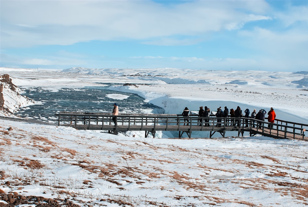 people walking on snow covered field during daytime