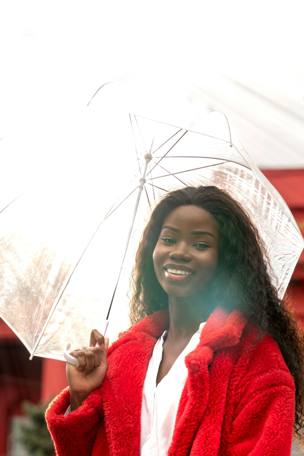 woman in red coat smiling
