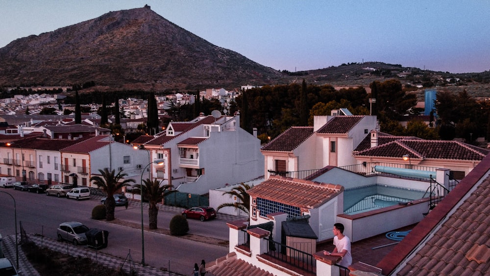 white and brown concrete houses near mountain under blue sky during daytime