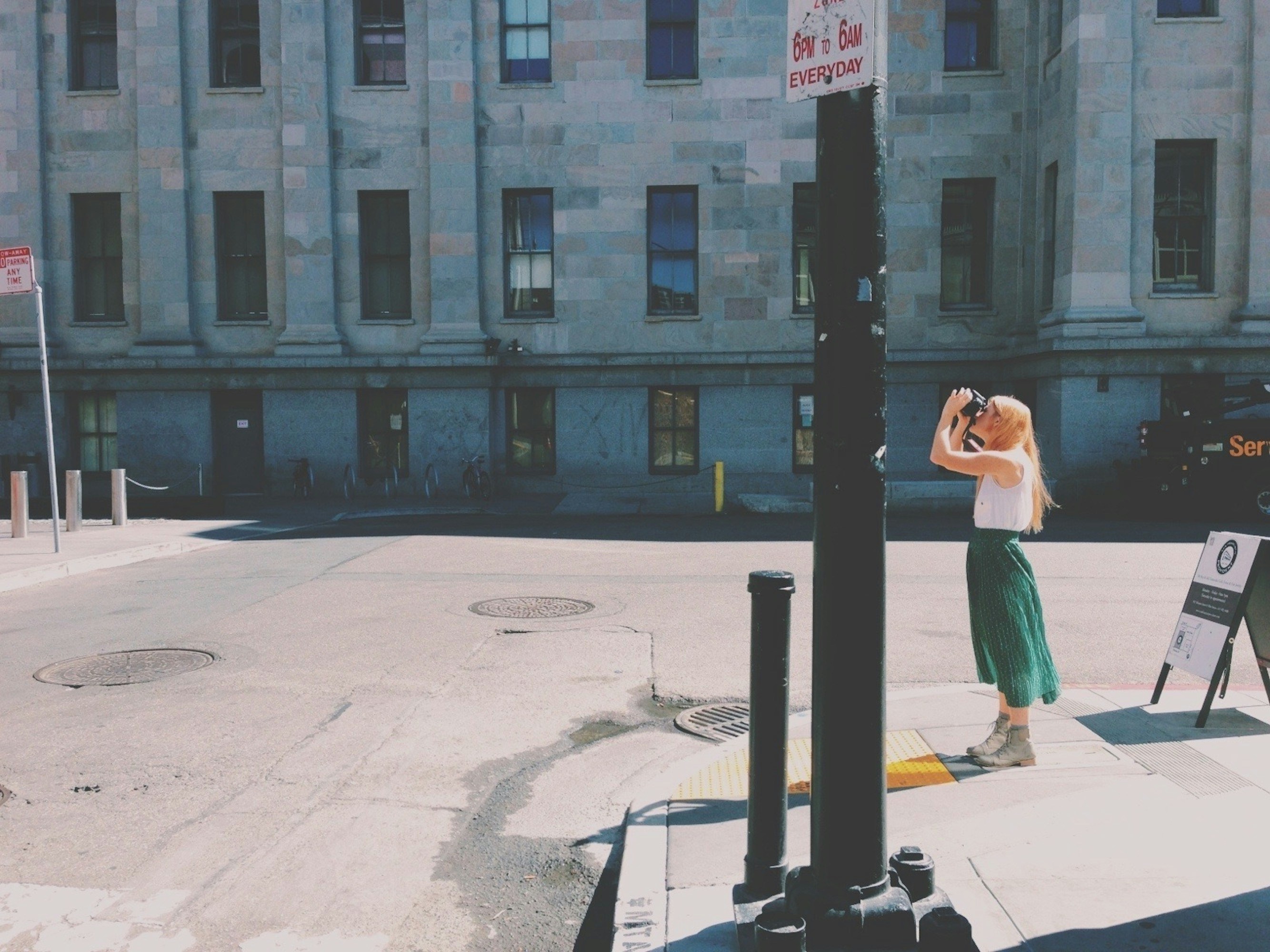 woman in green dress sitting on white bench during daytime, 