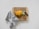 A wooden cutting board is placed on a light surface with sliced yellow bell peppers and chopped green onions neatly organized. A knife with a black handle lies next to the vegetables. Beside the cutting board, a grey textured cloth is casually draped.