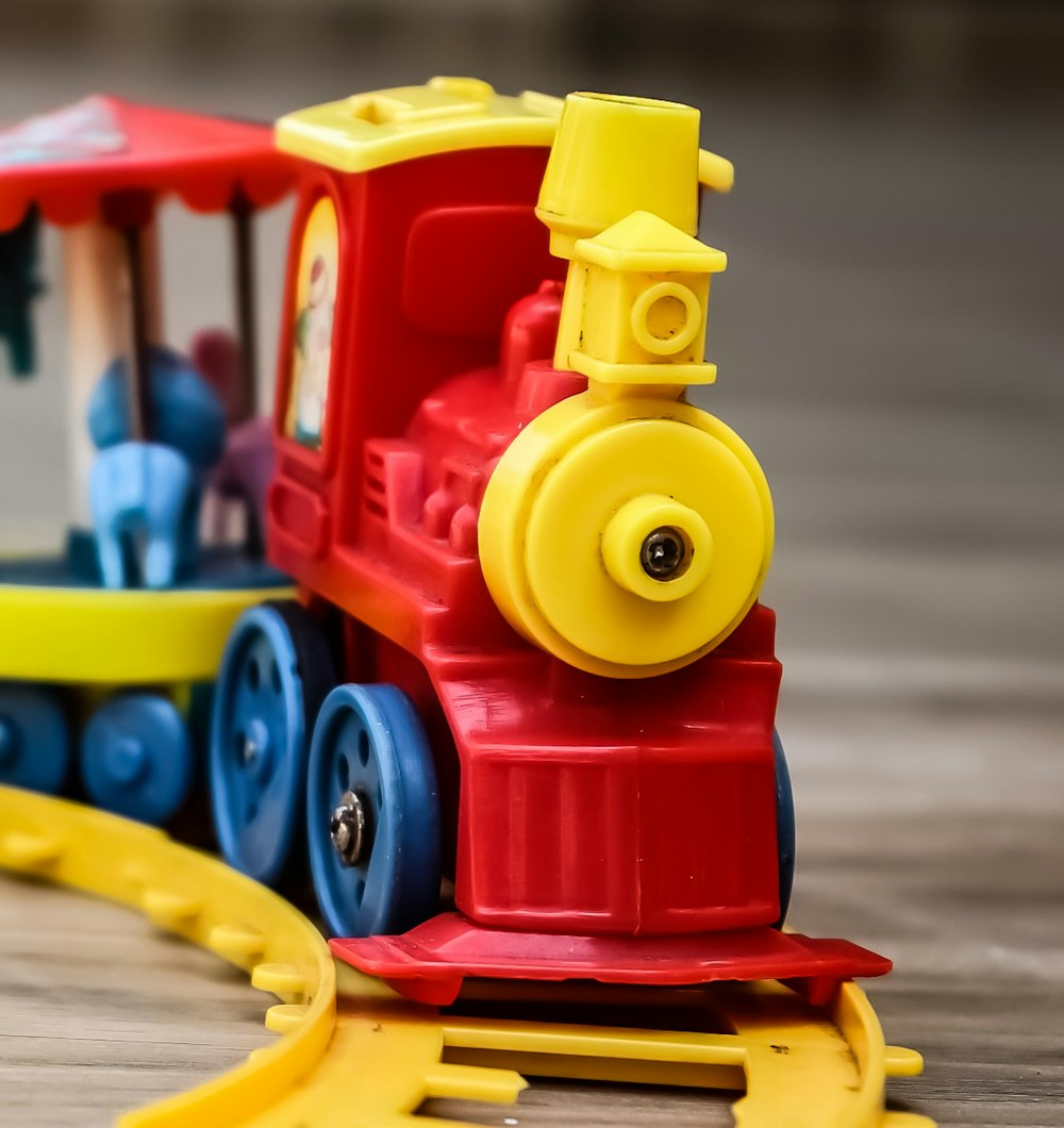 yellow red and blue plastic toy train