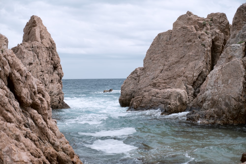 brown rock formation on sea during daytime