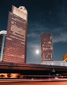 brown high rise building under dark clouds